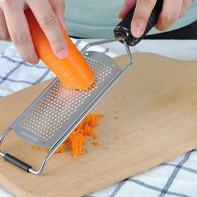 A versatile Cheese Grater featuring multiple grating surfaces for fine, medium, and coarse textures. Made from durable stainless steel with an ergonomic handle for comfortable use. Compact design with a hanging loop for easy storage. Ideal for grating cheese and vegetables in any kitchen setting.