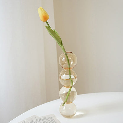 The Glass Bloom Vase, a transparent and sleek flower vase with a subtle bubble pattern, adds sophistication to any home decor. This versatile glass vase beautifully displays your favorite blooms, creating a stylish focal point in your living space, for home decor in Australia.