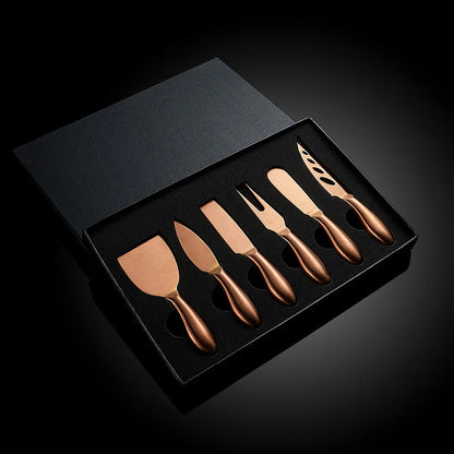 A premium Cheese Utensils Set featuring a pronged knife for semi-soft cheeses, a thin knife for slicing soft cheeses, a heart knife for cutting hard cheeses, a serving knife for elegant serving, a chisel knife for breaking crumbly cheeses, and a spreader knife for soft cheeses and pâtés. Crafted from high-quality stainless steel with ergonomic handles, these durable and easy-to-clean utensils add sophistication to any cheese platter.