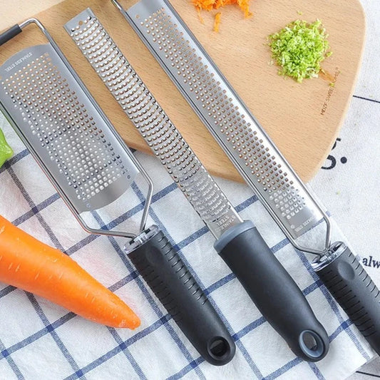 A versatile Cheese Grater featuring multiple grating surfaces for fine, medium, and coarse textures. Made from durable stainless steel with an ergonomic handle for comfortable use. Compact design with a hanging loop for easy storage. Ideal for grating cheese and vegetables in any kitchen setting.